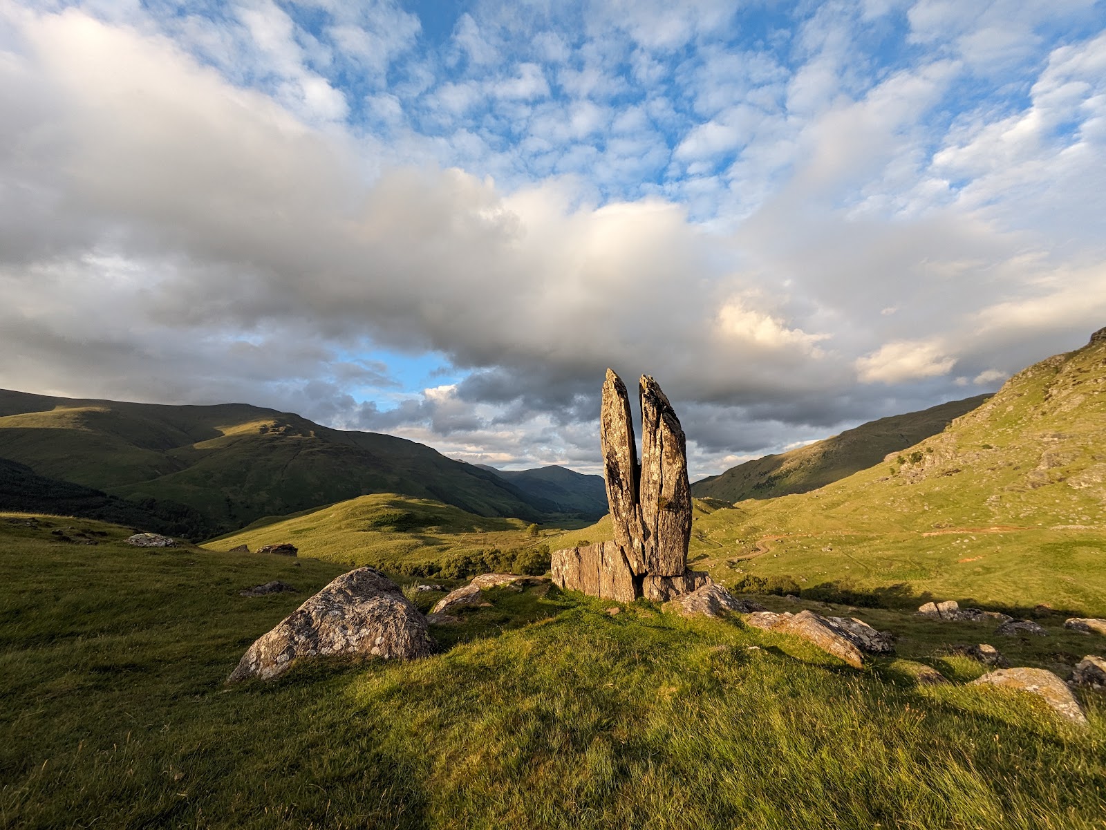 The split rock of the Praying Hands standing on the hillside above Glen Lyon in evening light.