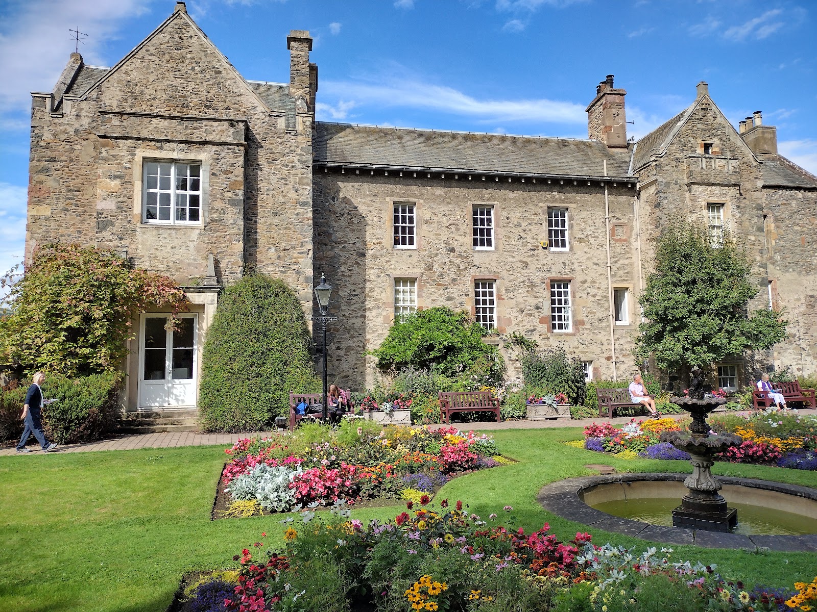 Old Gala House in Galashiels, a stone mansion with crow-stepped gables above a formal garden and fountain.