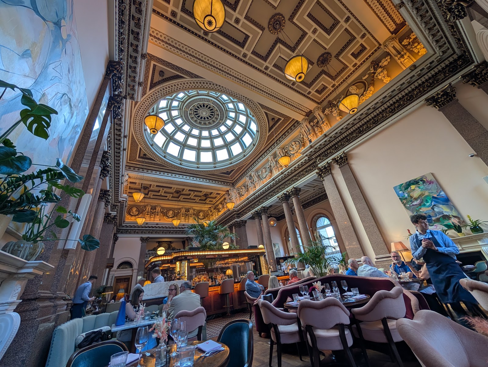 The banking hall at The Spence, Gleneagles Townhouse, with its glass dome, gilded ceiling and granite columns above diners and the central bar.