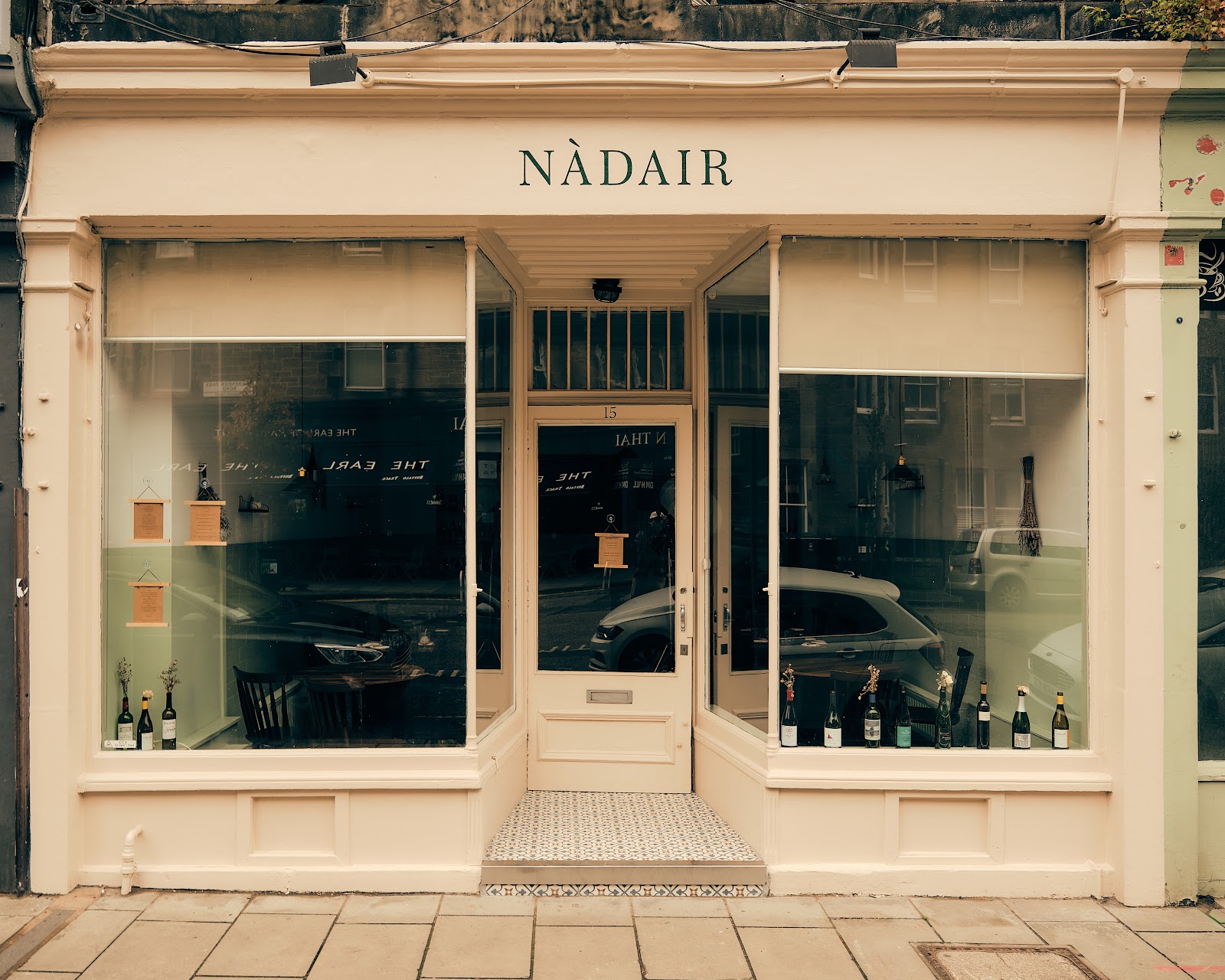 The cream-painted shopfront of Nàdair at 15 Roseneath Street in Marchmont, its name in green above the door and wine bottles along the windows.