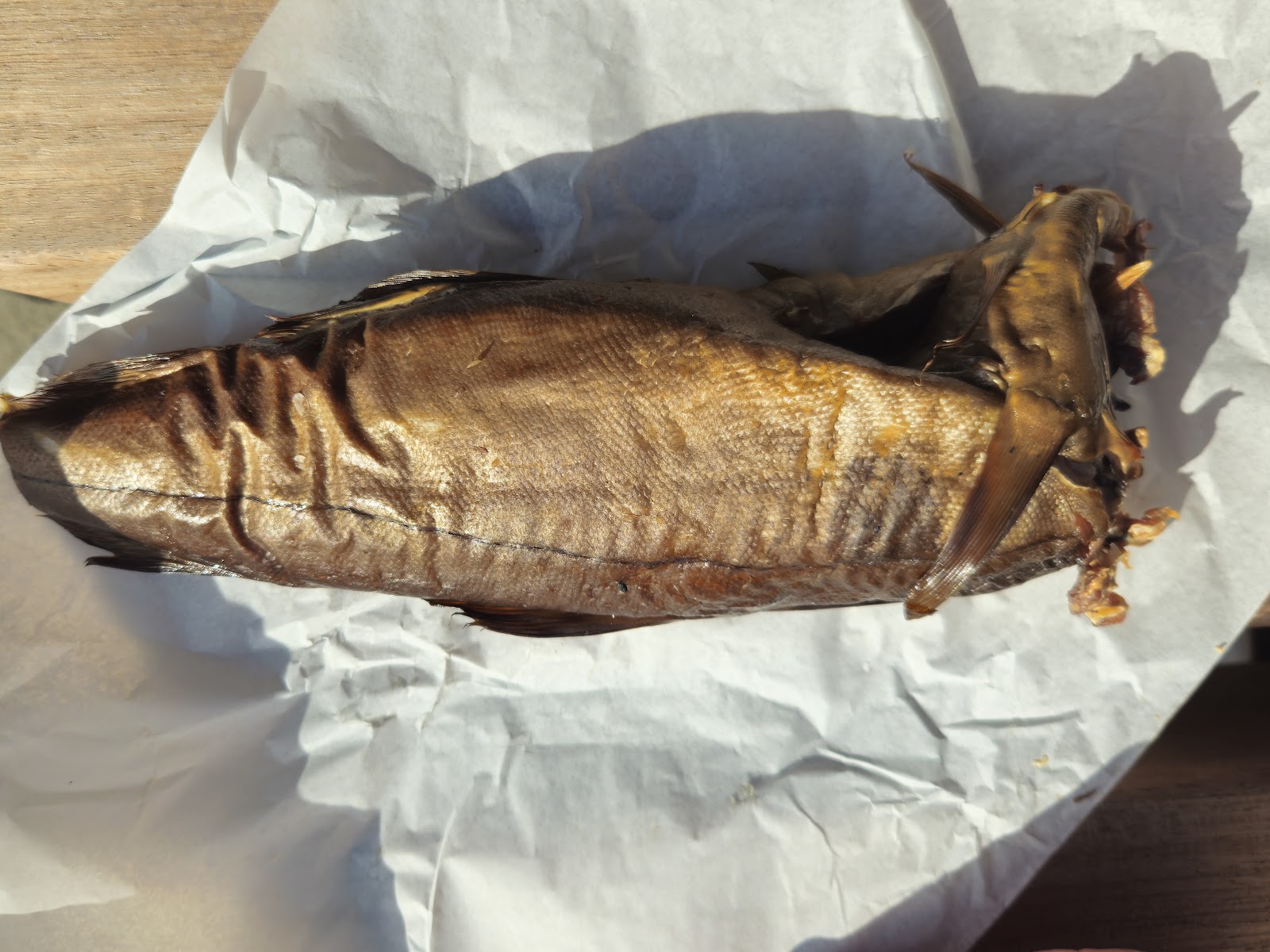 A golden Arbroath smokie wrapped in paper from E&O Fish.