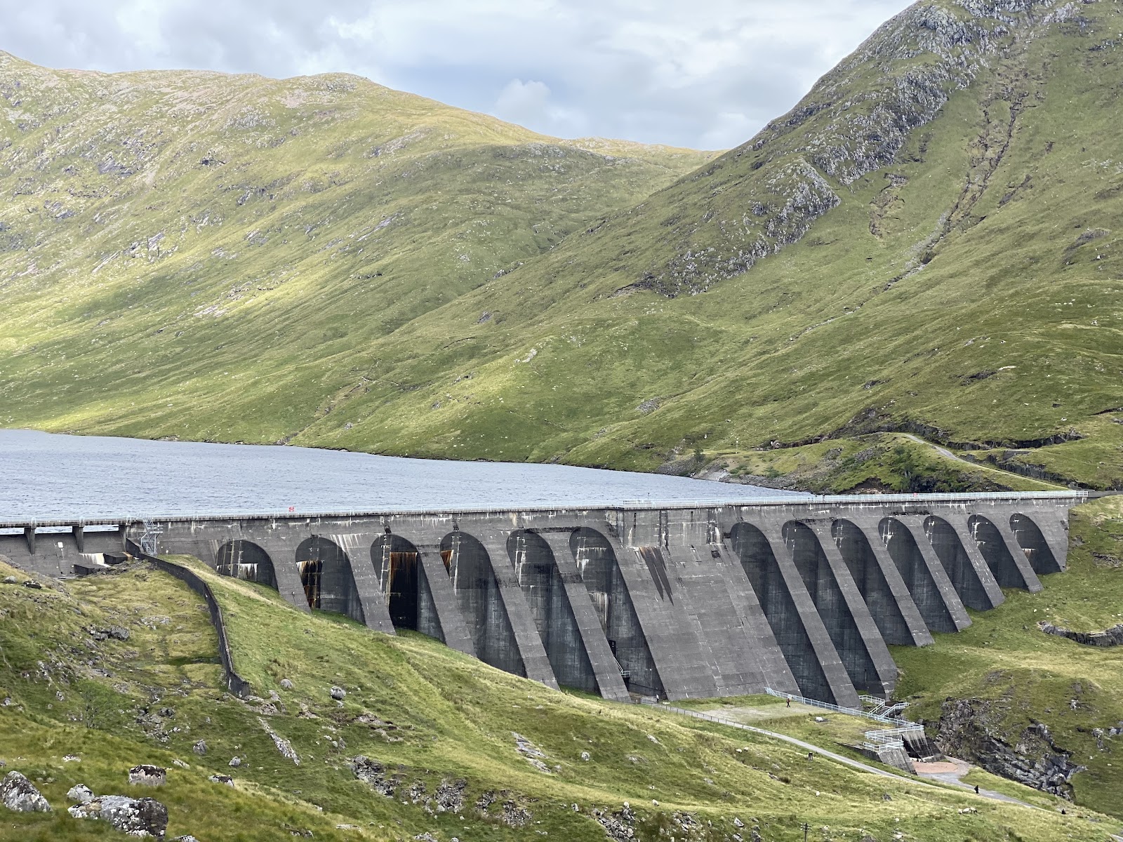 The buttressed concrete wall of the Cruachan dam holding back the reservoir high on Ben Cruachan.
