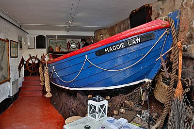 The blue surf boat Maggie Law on display inside the museum at Gourdon.