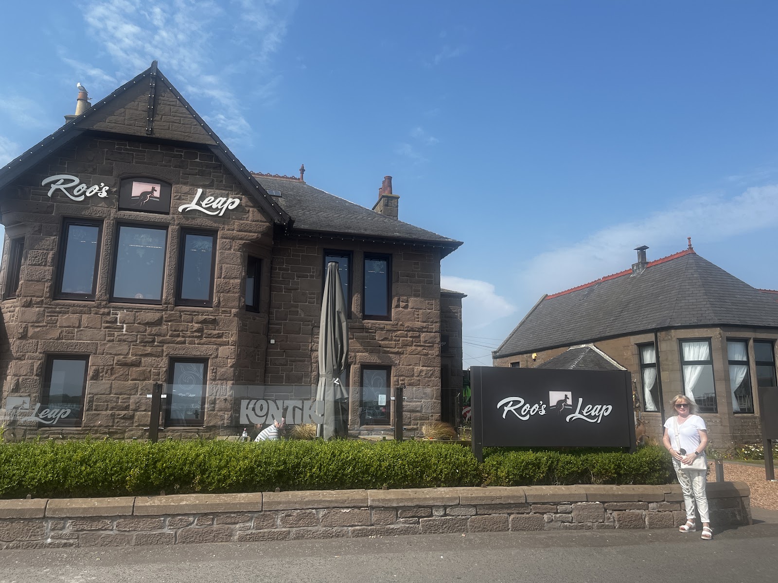 The sandstone clubhouse of Roo's Leap by the Montrose links.