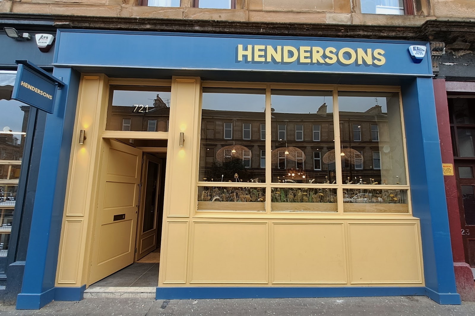 Hendersons' blue and yellow front at 721 Pollokshaws Road, its door open.