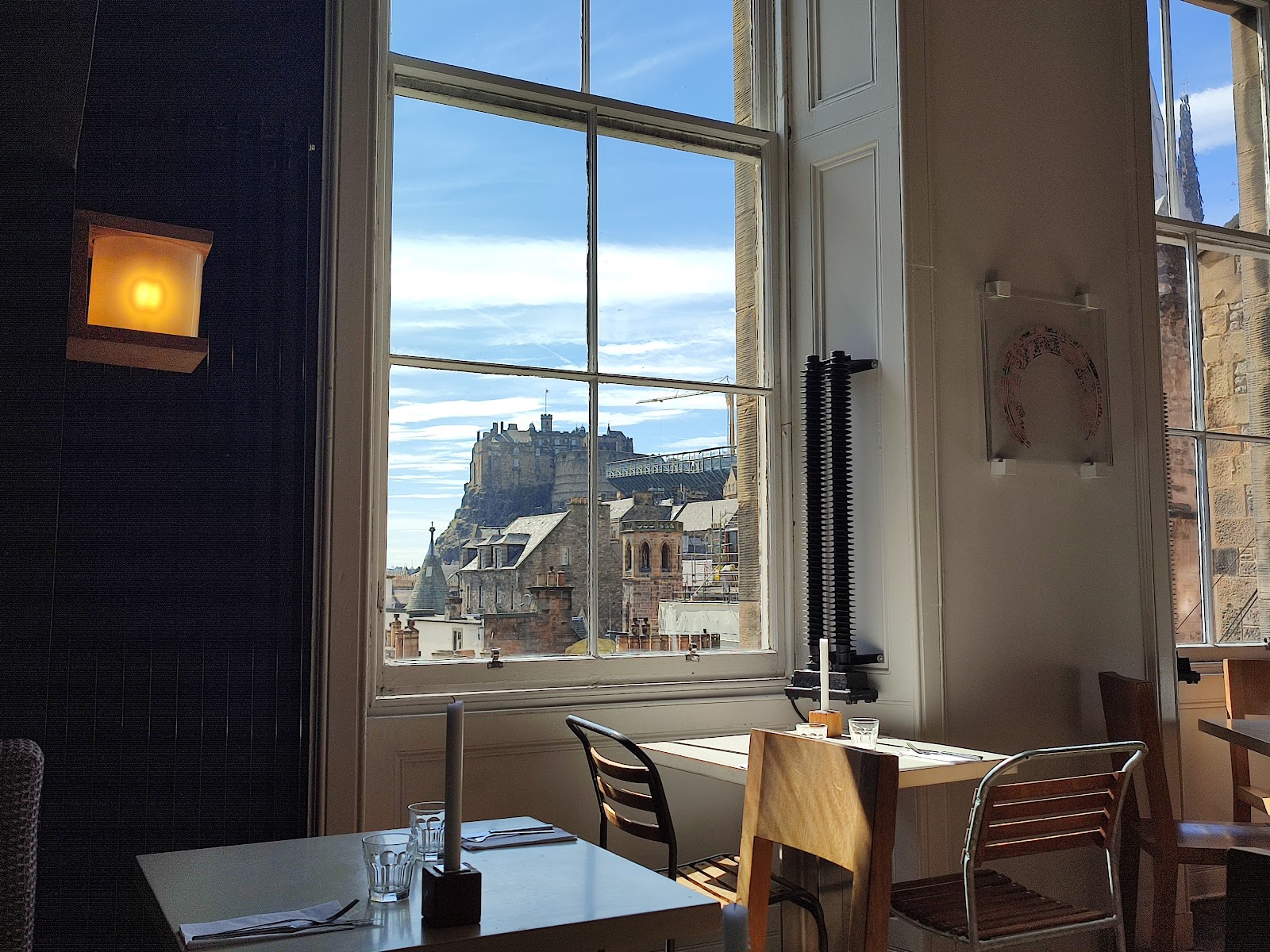 A window table at the Outsider, the castle filling the glass.