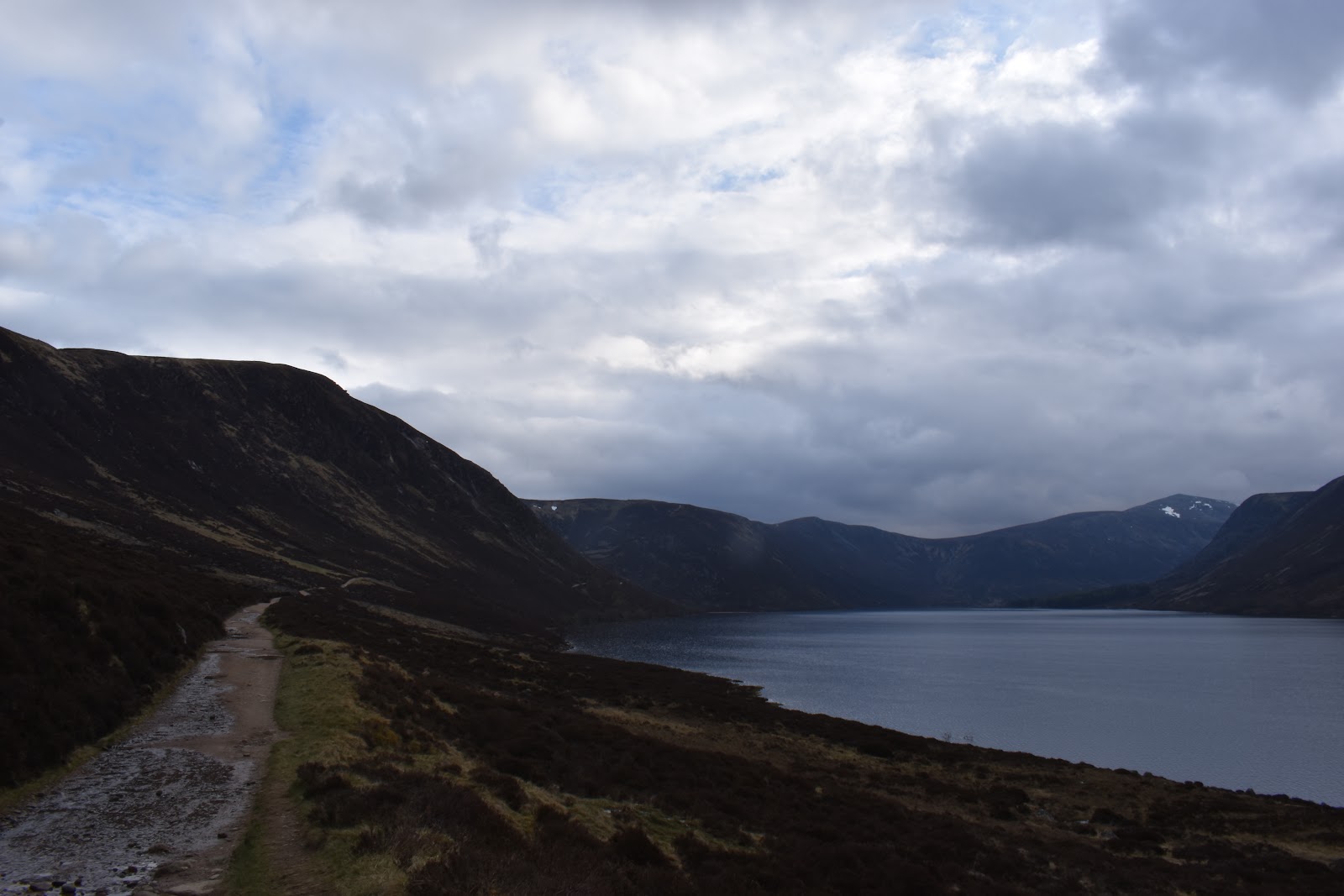 Loch Muick stretching away between steep hills under cloud.