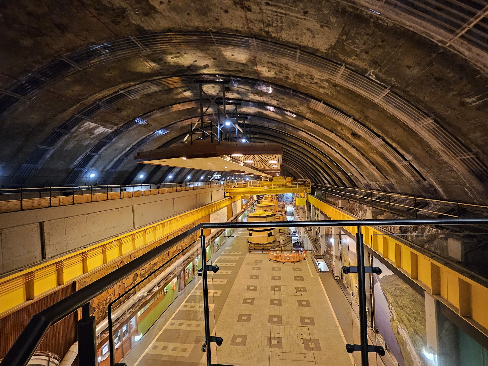 The machine hall inside Ben Cruachan, a long vaulted cavern with yellow cranes over the turbines.