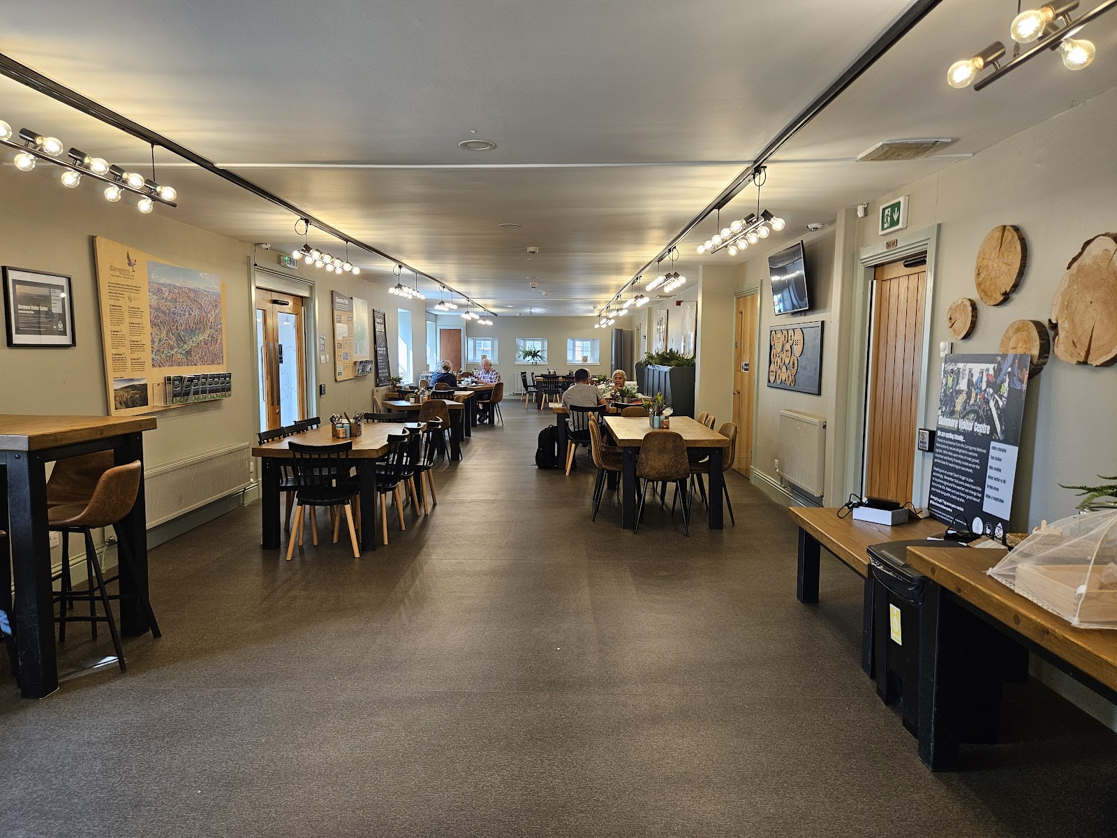 Inside the refurbished café, tables along the windows.