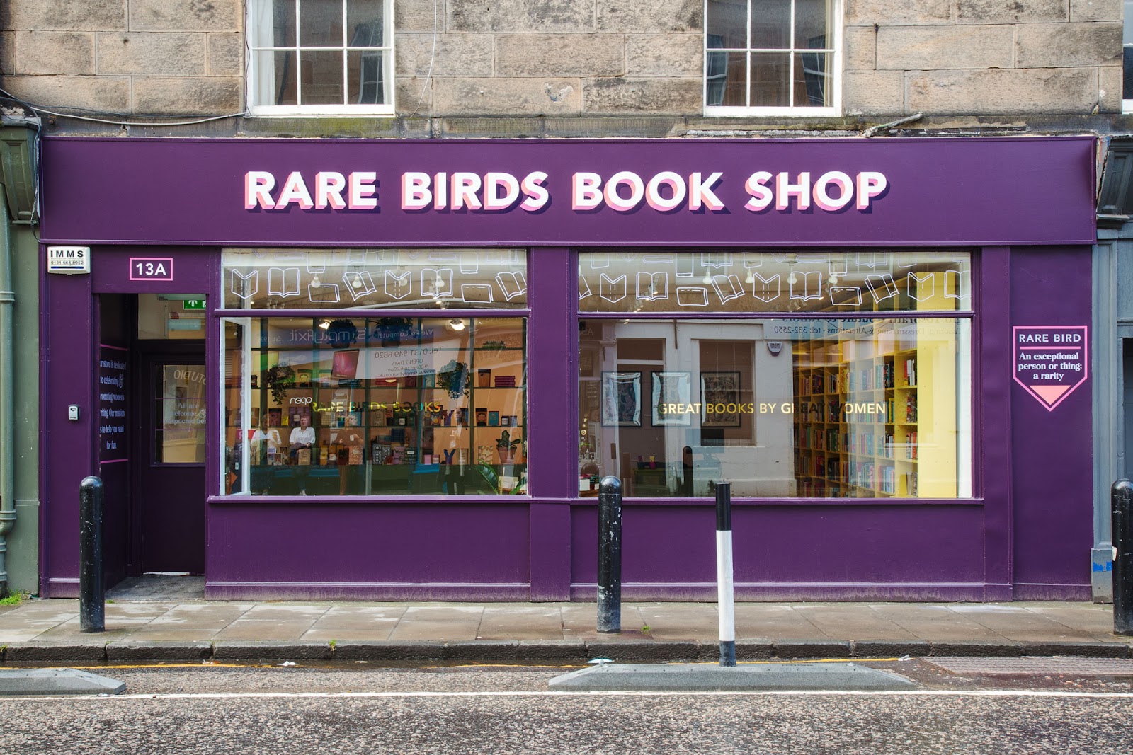 The purple front of Rare Birds Book Shop at 13a Raeburn Place in Stockbridge, its name in white capitals above two wide windows.