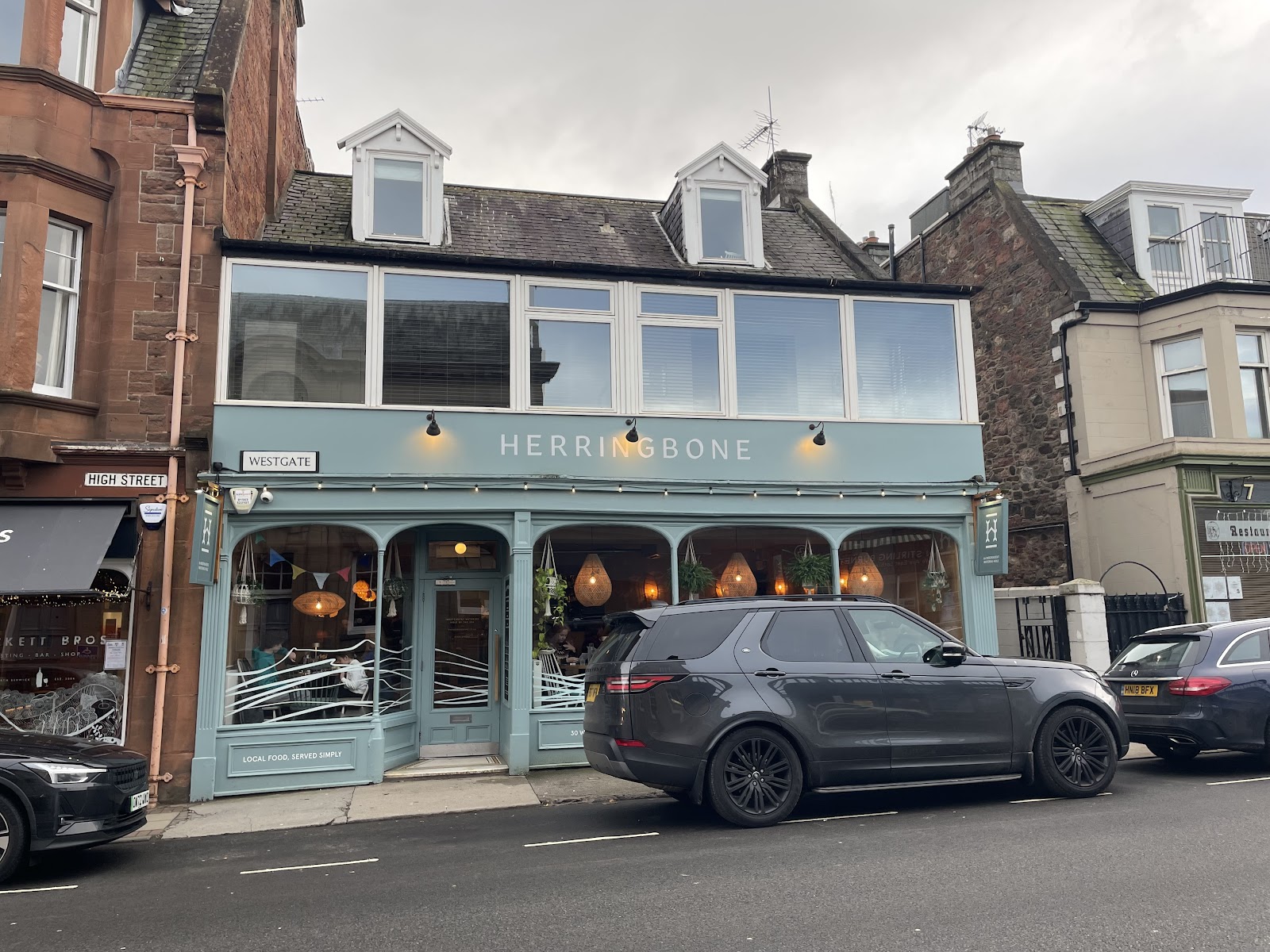 The Herringbone on Westgate in North Berwick, a pale green frontage with arched windows.