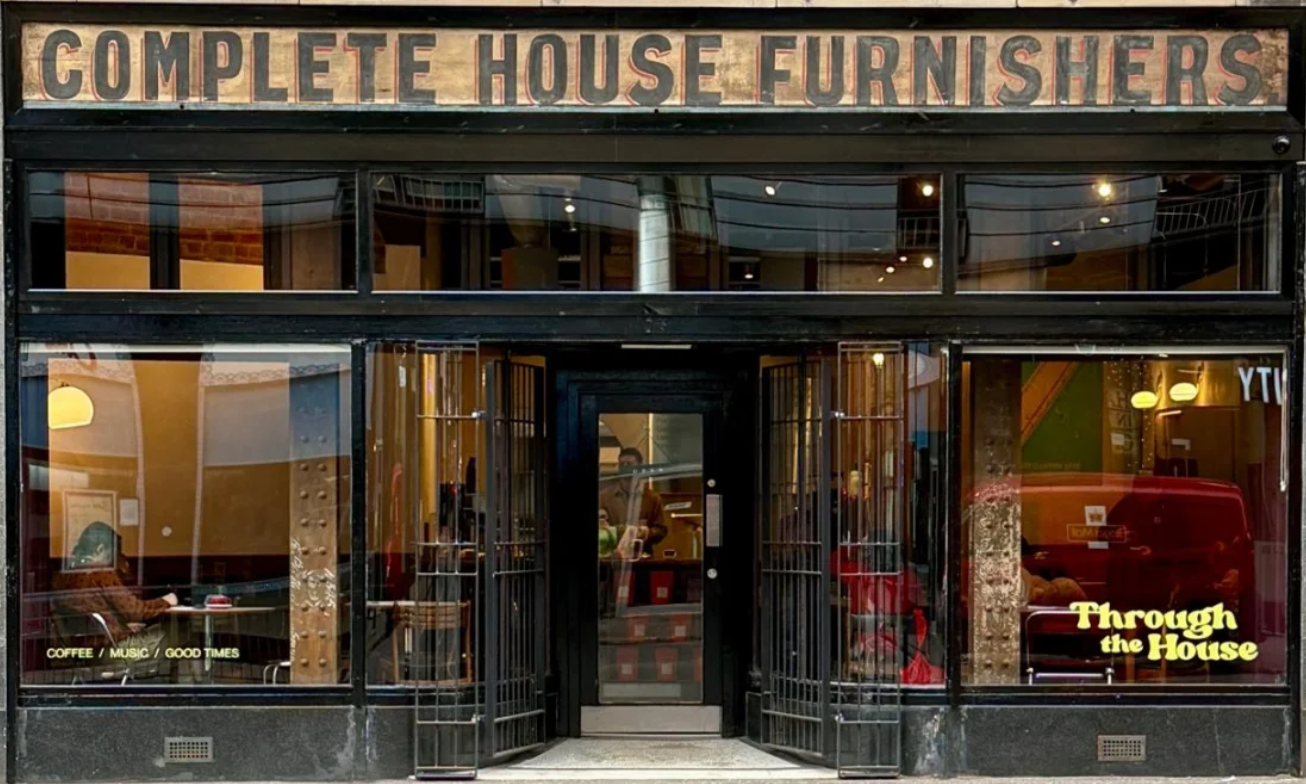 Through the House on High Street, its glass front under an old painted sign for Complete House Furnishers.