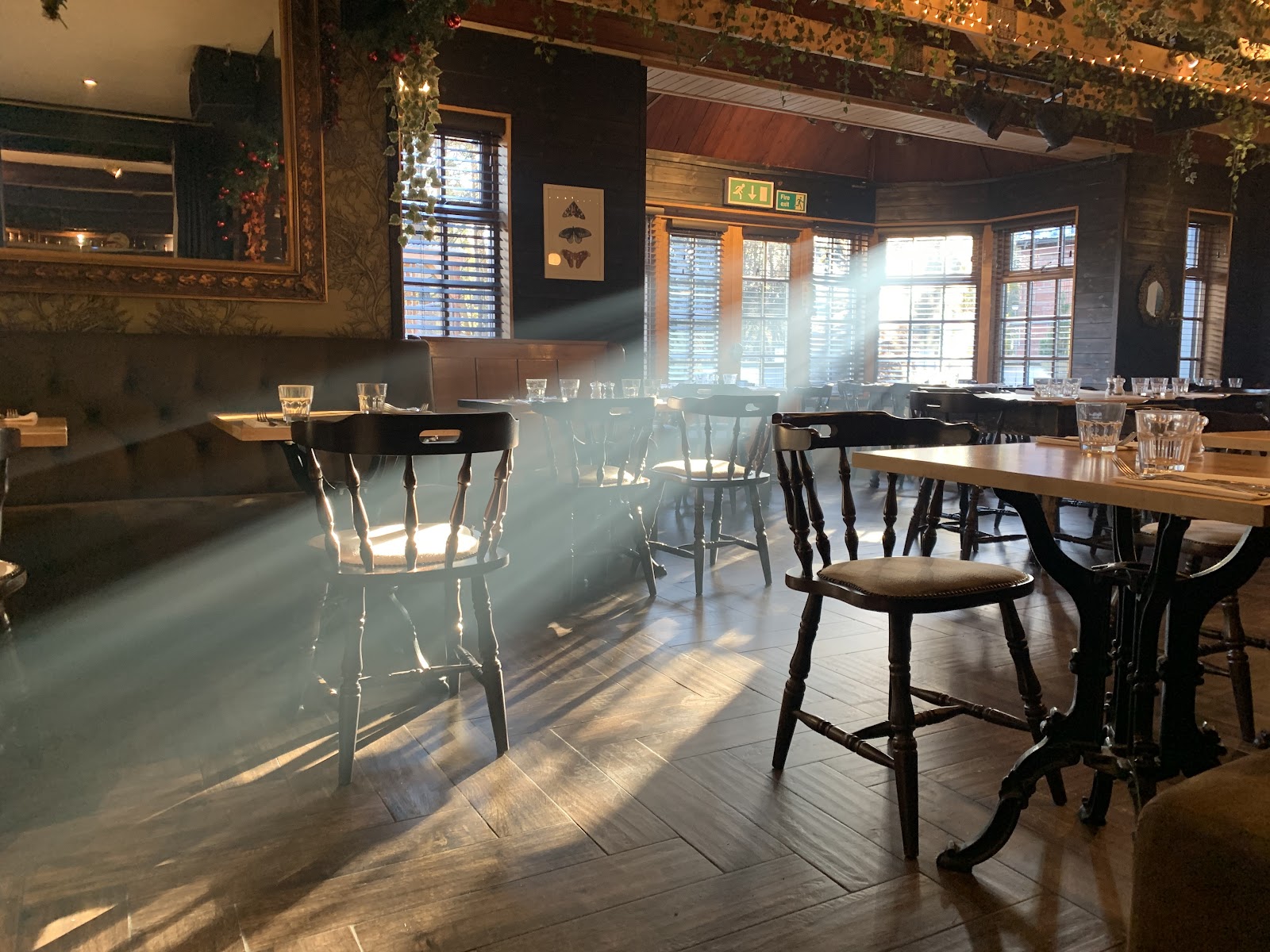 Sunlight slanting across the tables and wooden chairs in the Old Bridge Inn's dining room.