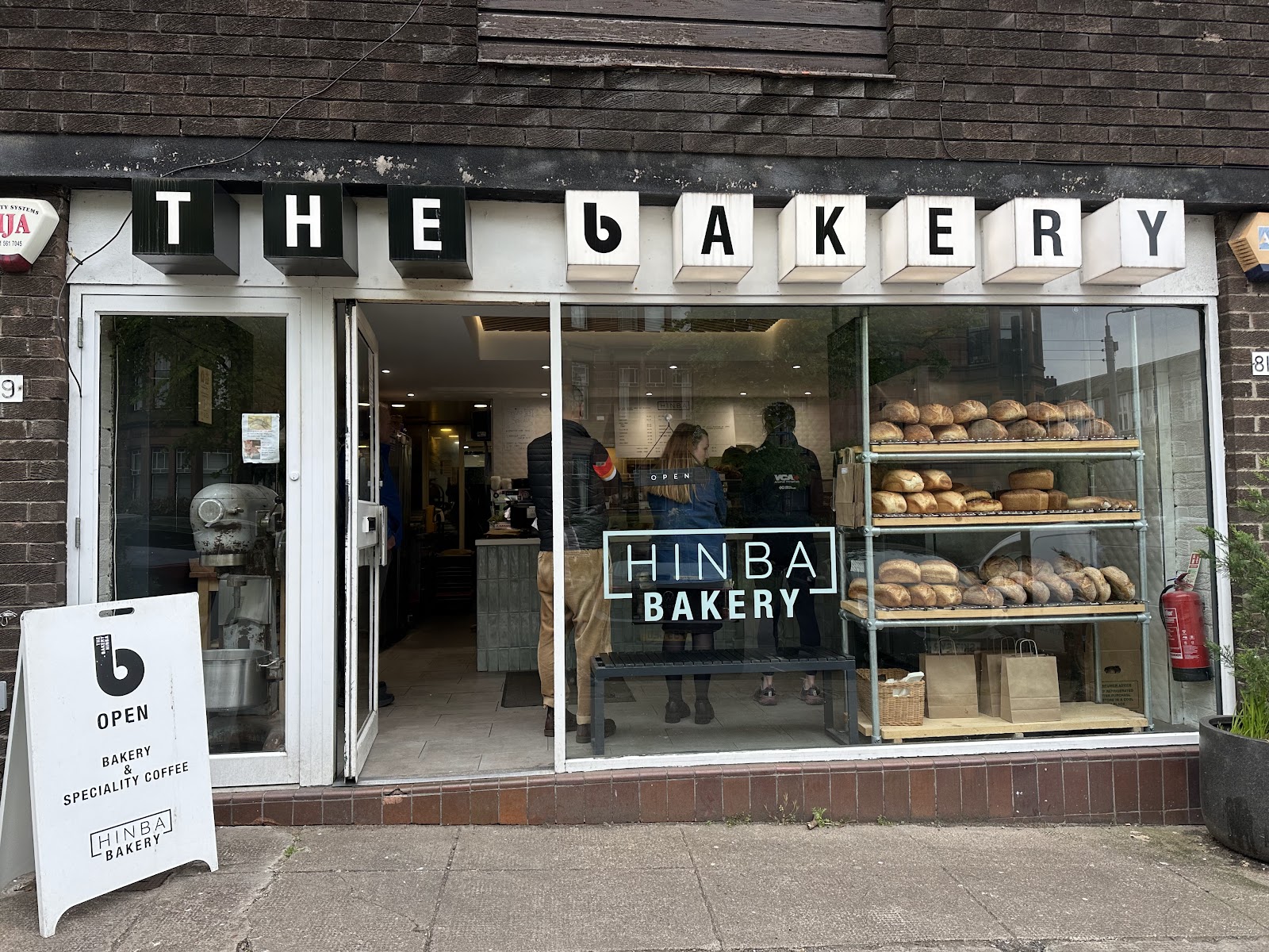 The Bakery Hinba's front on Lauderdale Gardens in Hyndland, its big window full of sourdough loaves on the shelves.
