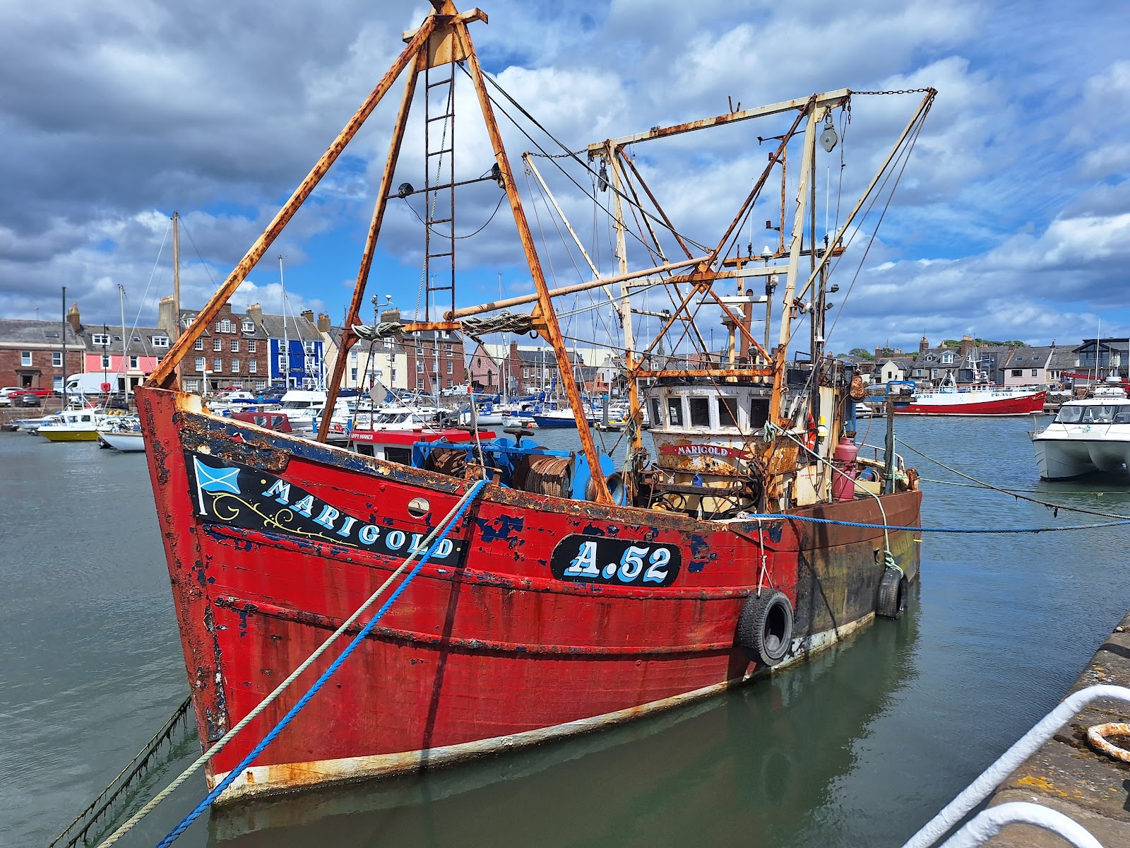 A red fishing boat tied up in Arbroath harbour.