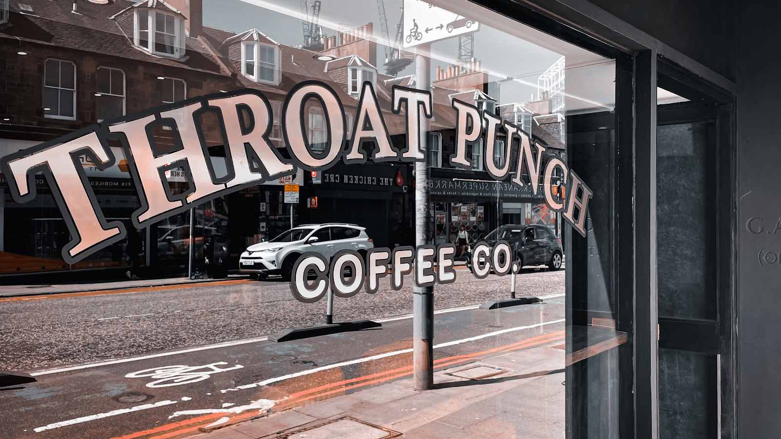 The Throat Punch name lettered on the window on Dalry Road.