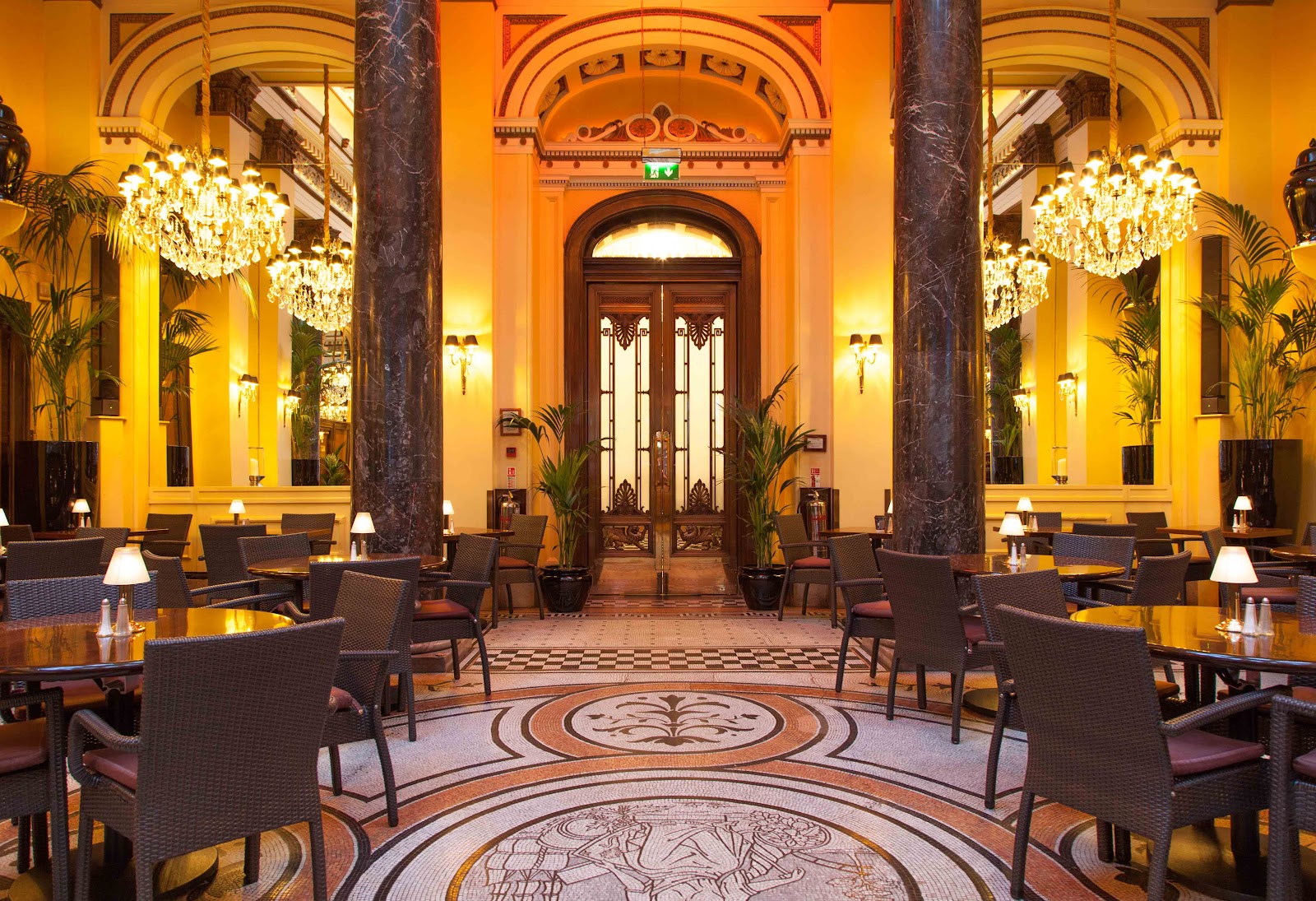 The Grill Room at the Dome, marble columns and chandeliers under the dome.