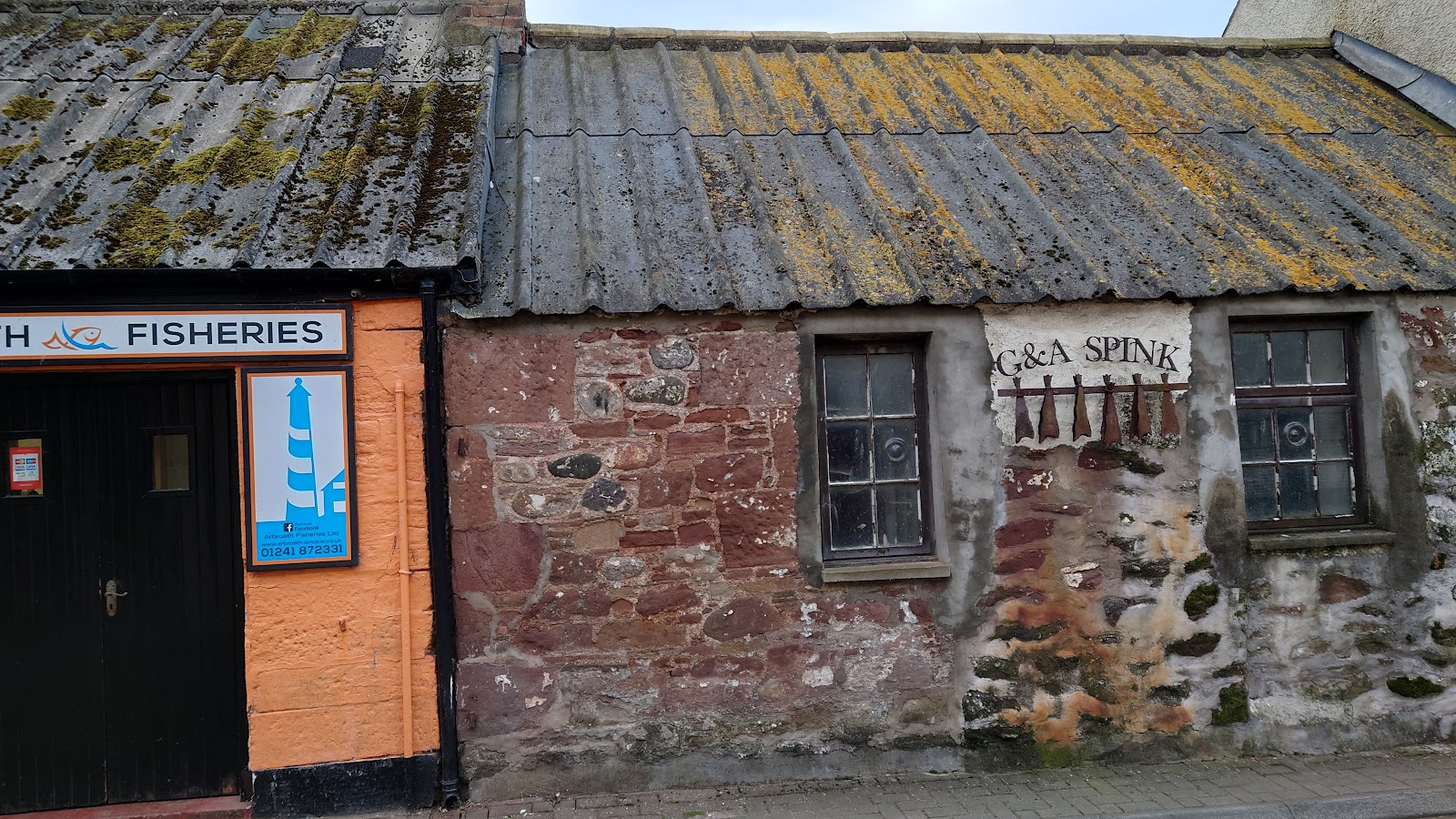 The old stone smokehouse of Arbroath Fisheries with its orange doors on Seagate.