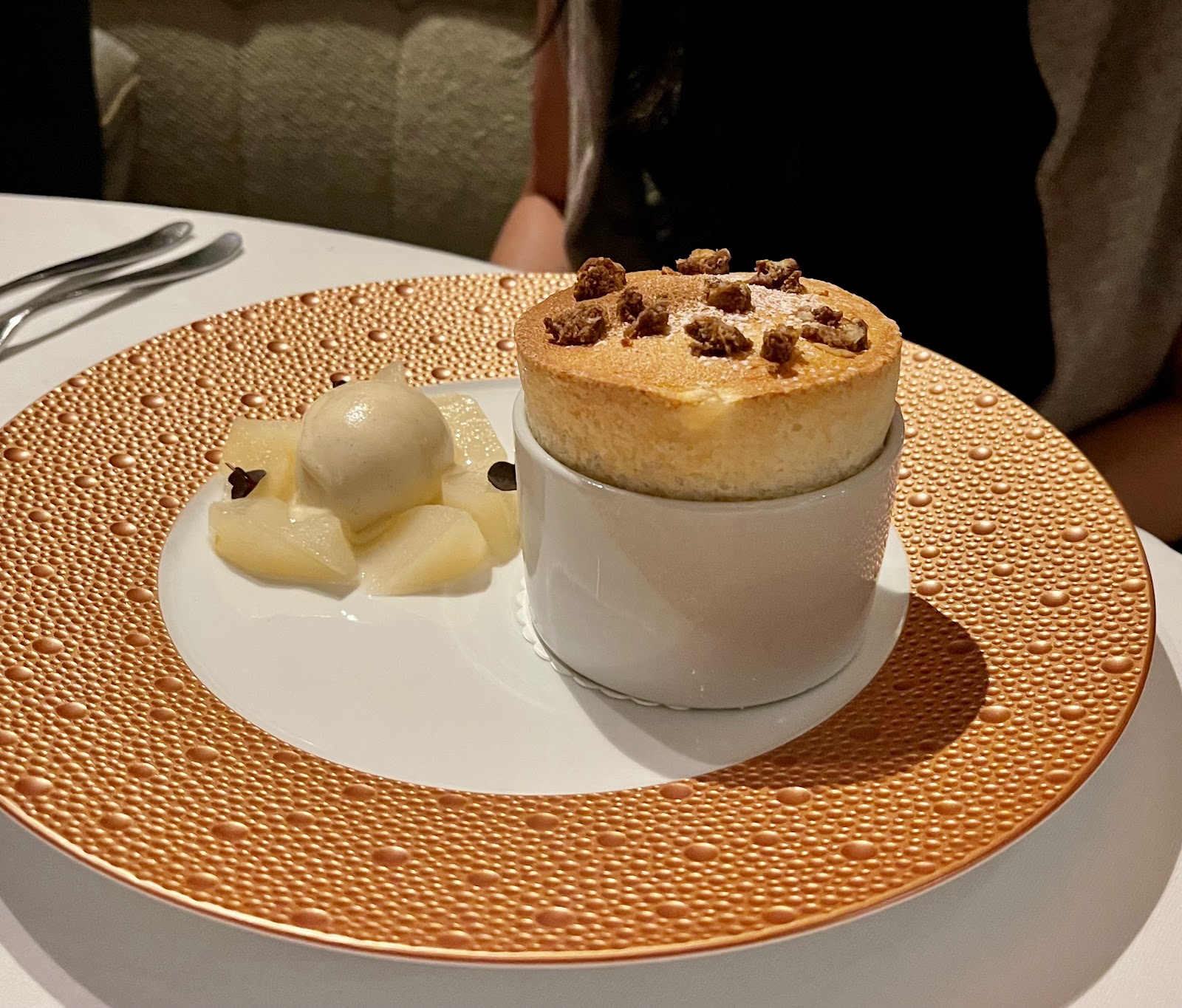 A pear soufflé with a crumble topping, beside poached pear and a scoop of ice cream on a gold-rimmed plate, at Restaurant Andrew Fairlie.