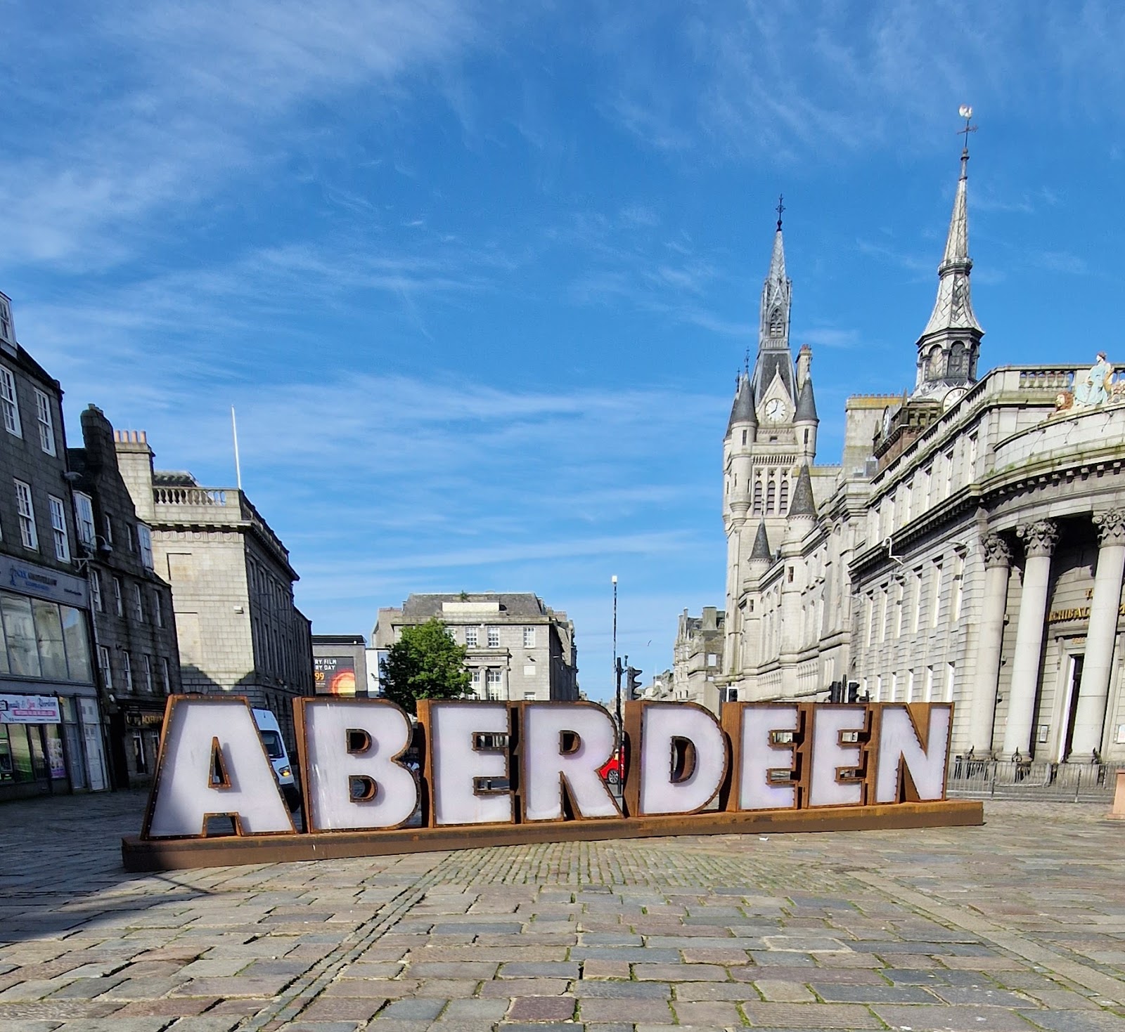 Union Street at dusk, granite buildings and a spire down the long straight street.