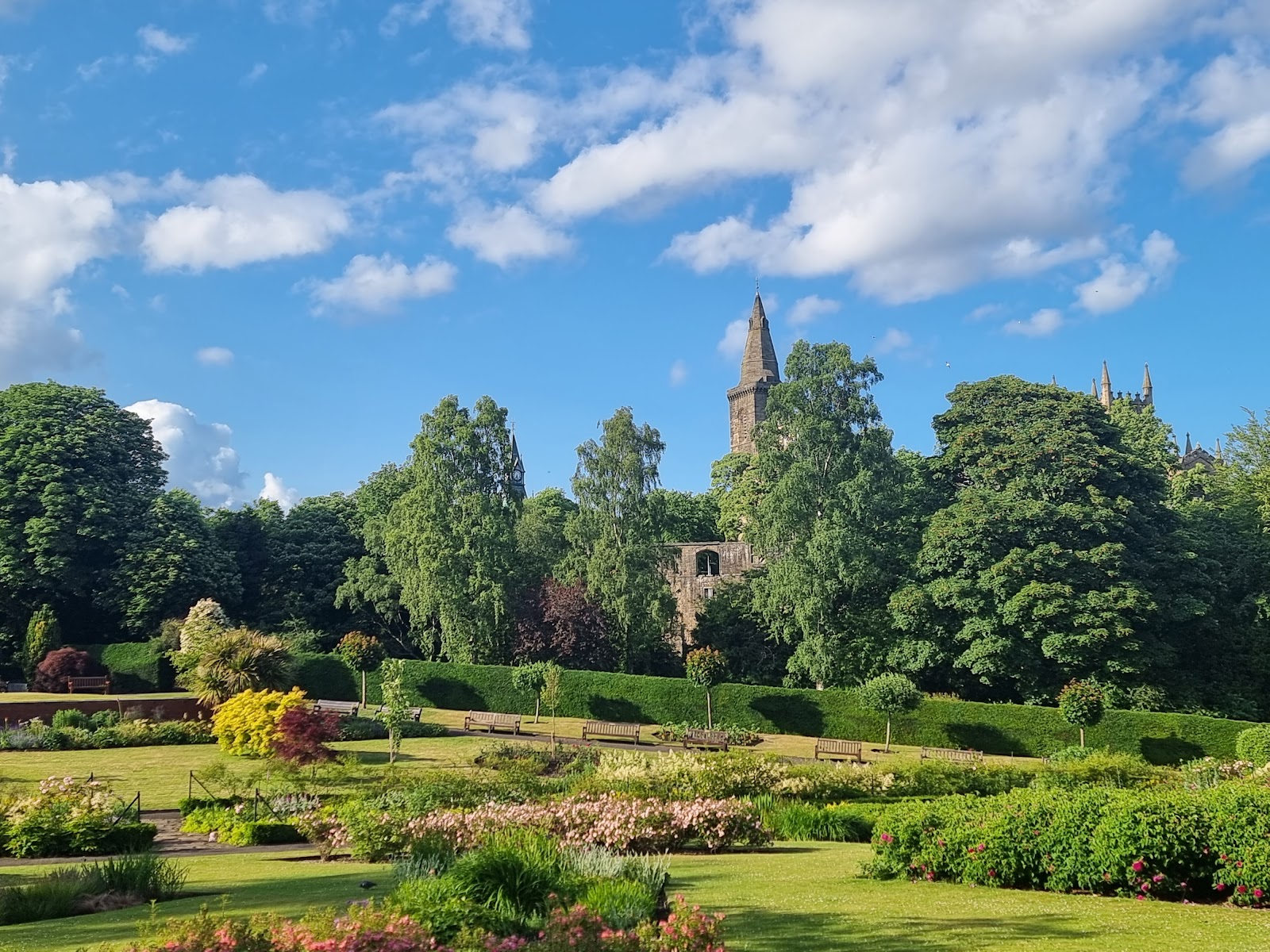 Pittencrieff Park, flower beds and lawns below the tower of Dunfermline Abbey.
