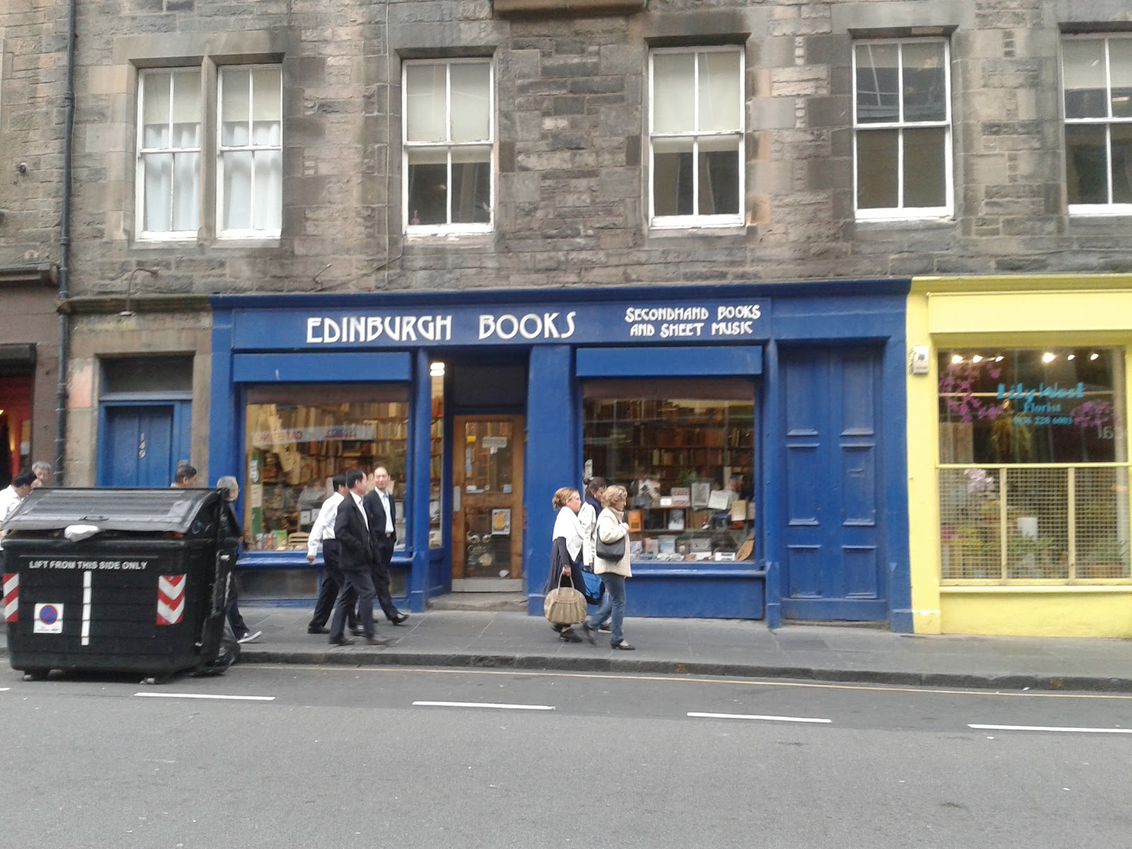 The deep blue shopfront of Edinburgh Books on the West Port, books in both windows.