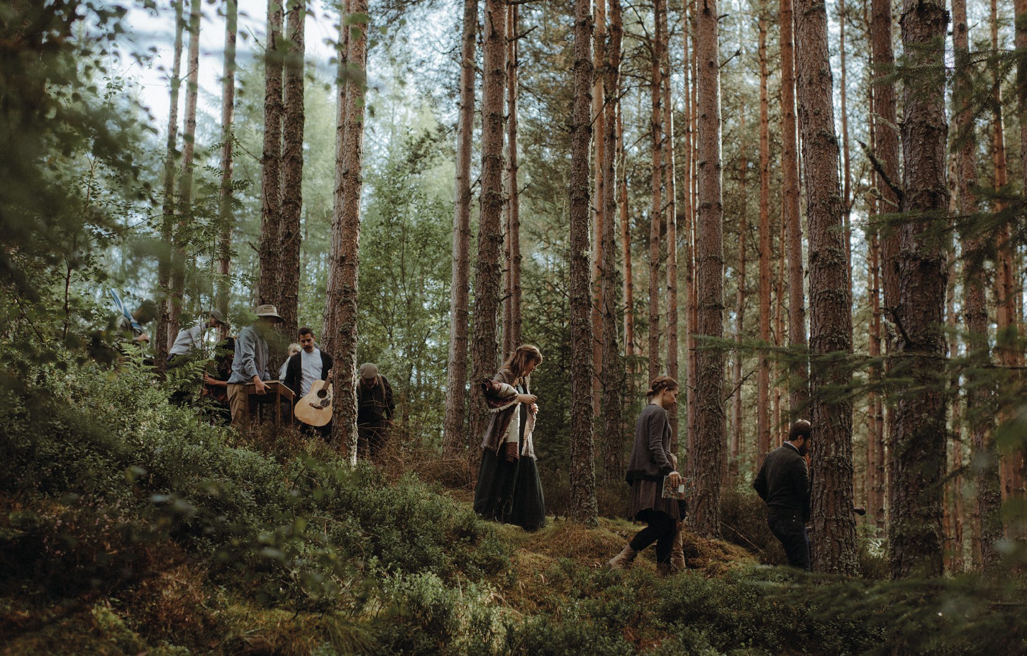 Forest ceremony with guests among the pines