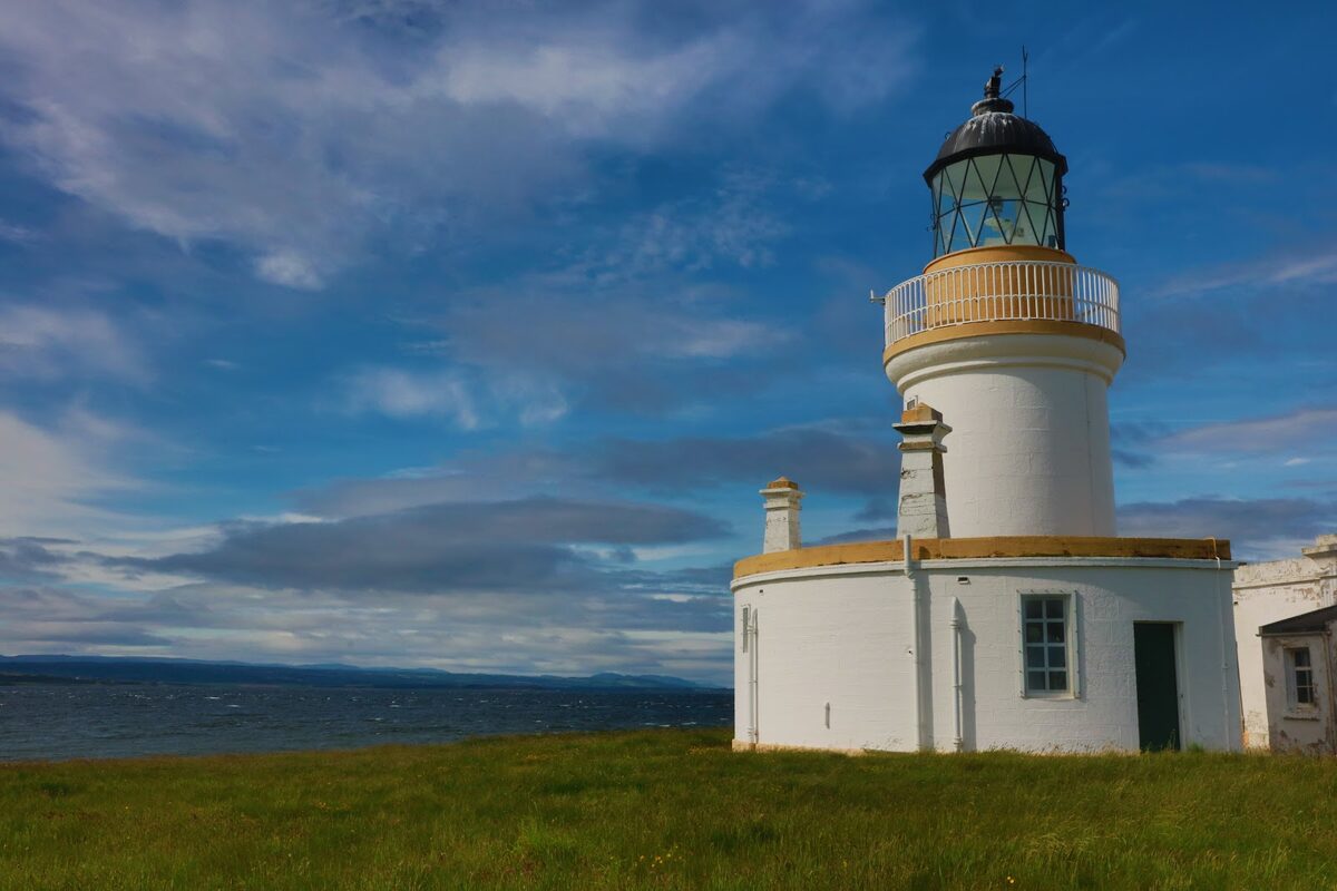 White lighthouse with black lantern room overlooking the Moray Firth