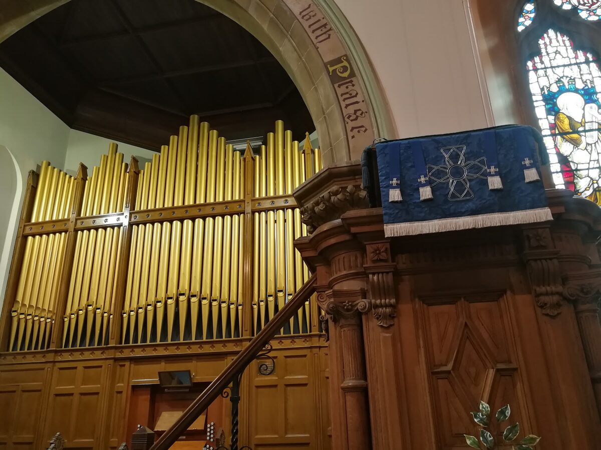 The gilded pipes of the Willis organ and the carved wooden pulpit inside the Old High Church, Inverness.