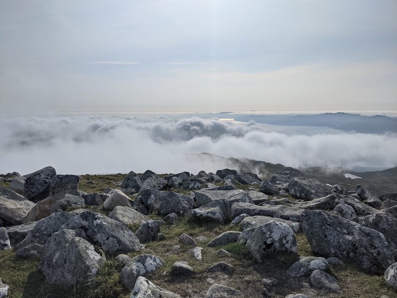 Boulders on a high top above a sea of cloud.