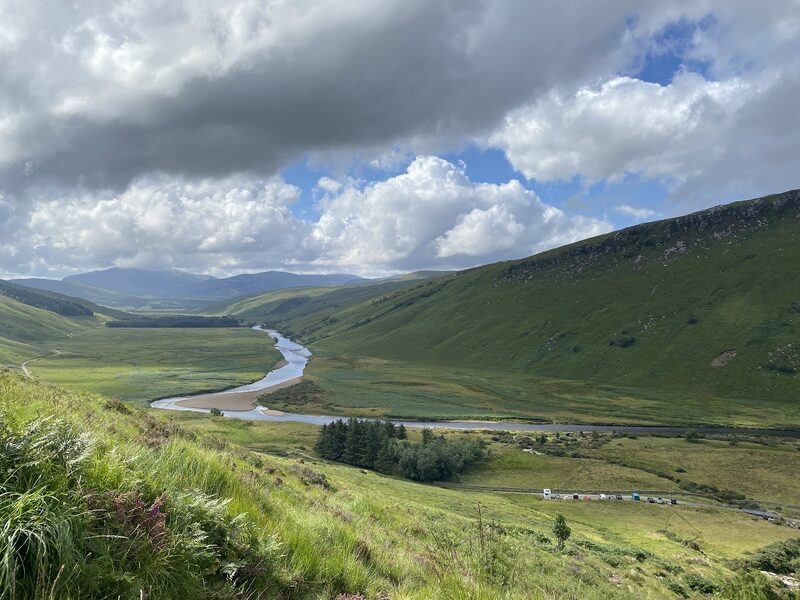 The strath and its river from the lower slopes of Ben Hope, green hillsides under broken cloud.