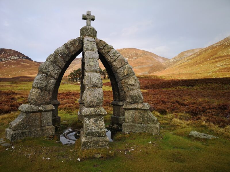 The stone crown over the Queen's Well in Glen Mark, on the way in from Invermark, heather hills behind.