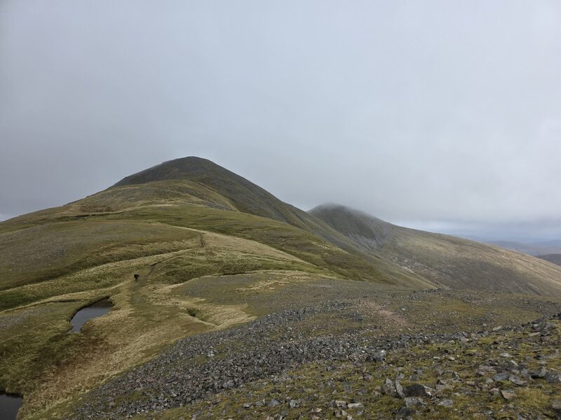 The grassy ridge of Gulvain rising to a rounded top, cloud close above.