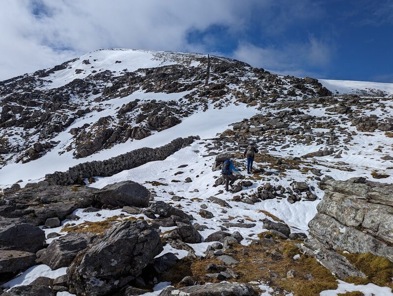 The drystone wall climbing the snowy ridge of Beinn Dearg towards its top.