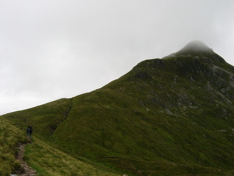 The steep green cone of Sgùrr Chòinnich Mòr, its top in cloud.