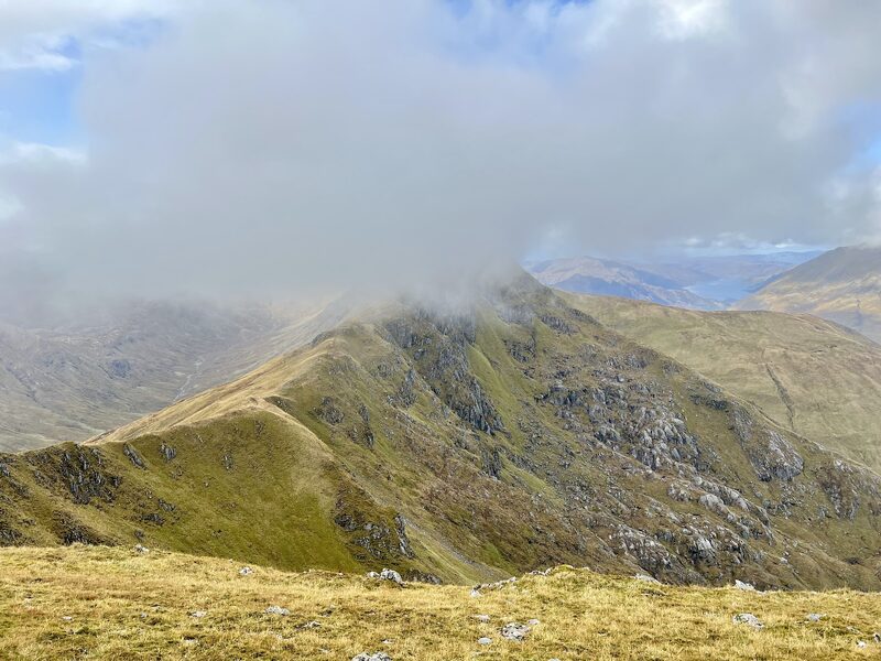 A green ridge on Maol Chinn-dearg with cloud pouring over its crest.