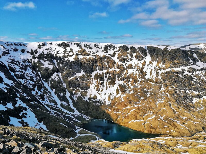 A blue lochan in the snow-patched corrie below Stob a' Choire Odhair.