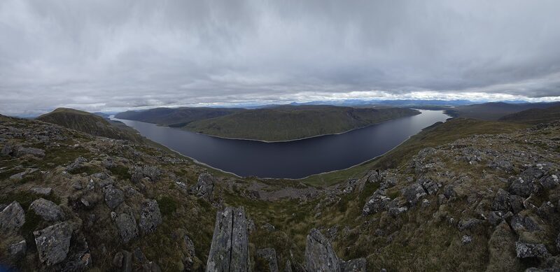 Loch Ericht far below the rocky edge of the top under grey cloud.