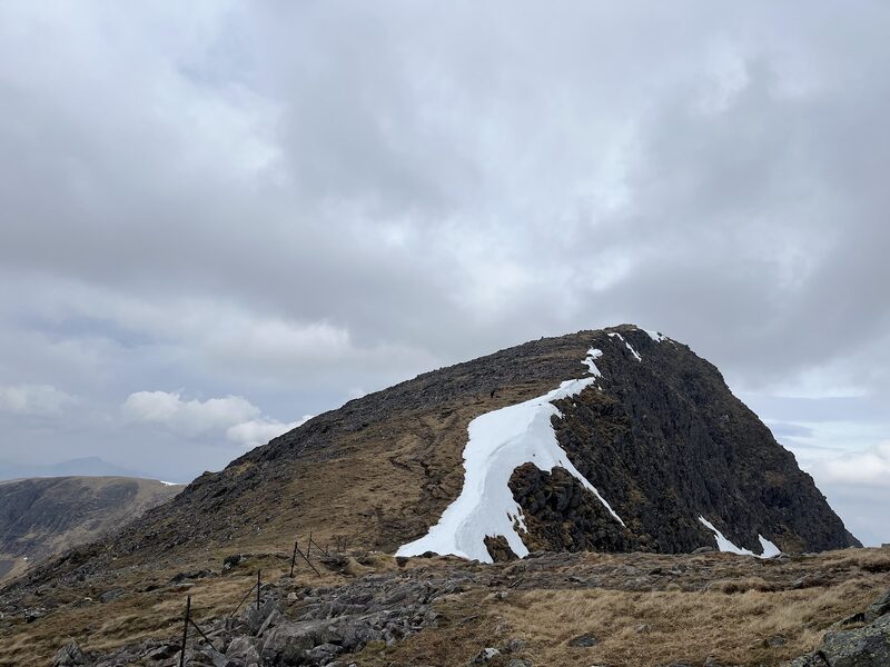 The dark top of Stob a' Choire Odhair with a long snow patch on its face.