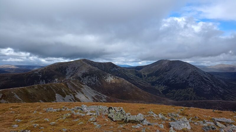 The view from the top of Càrn Liath along the ridge to the other summits of Beinn a' Ghlò, scree and moss in front.