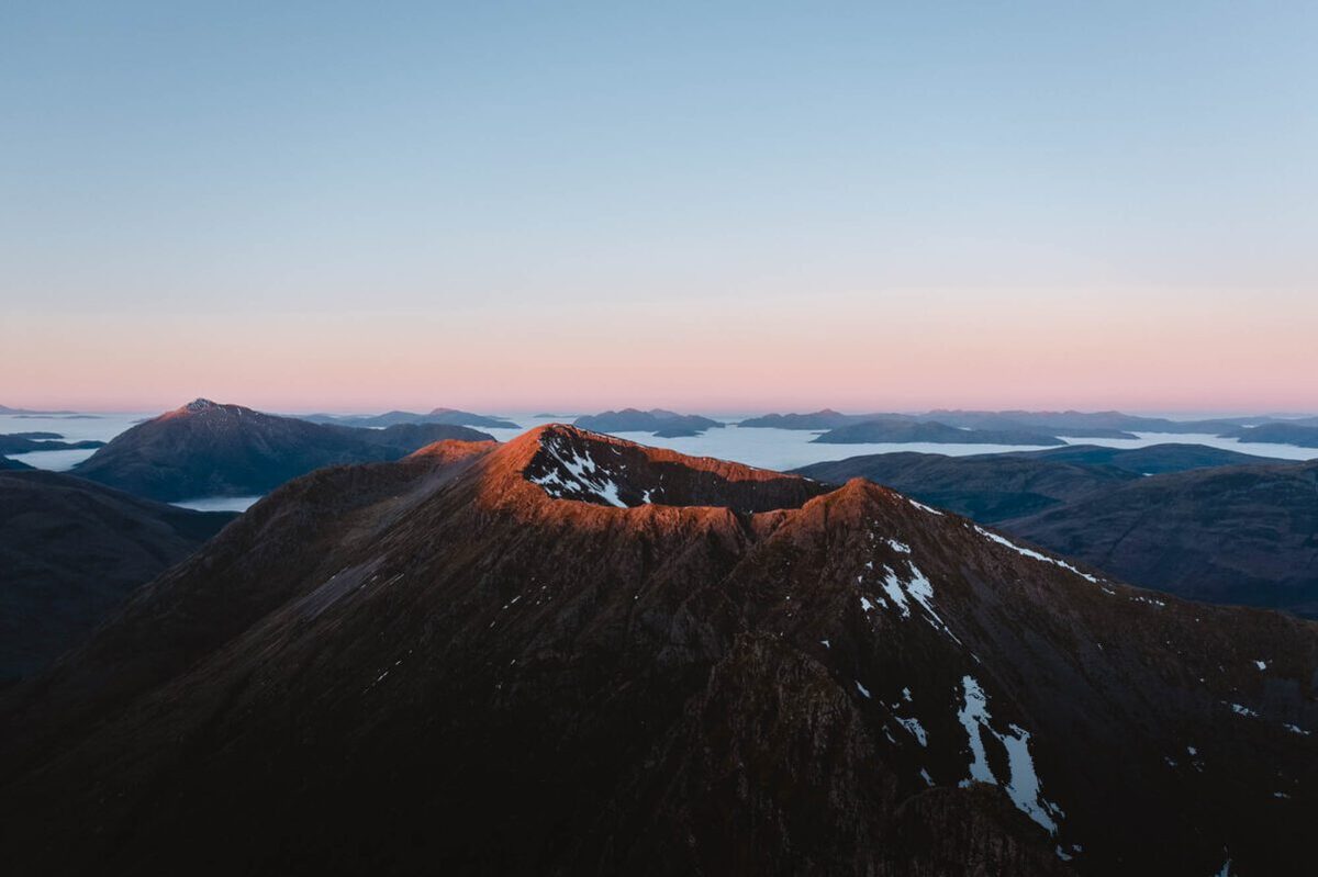 The Aonach Eagach ridge at first light, snow in its gullies.