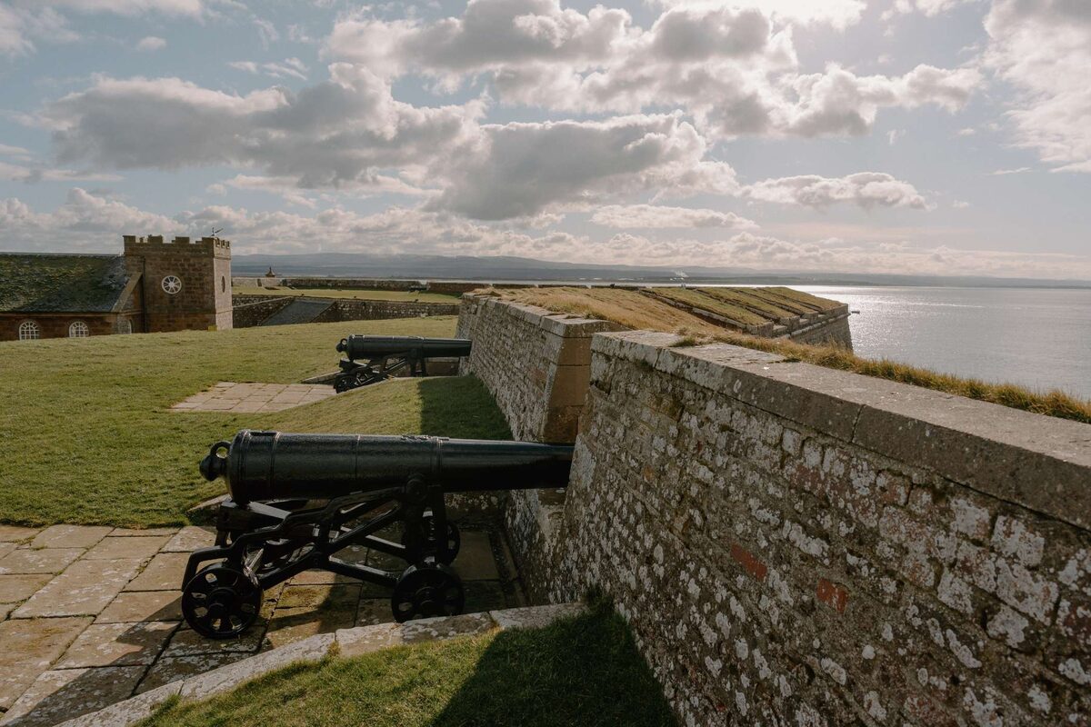 Cannons line the fort's ramparts overlooking the coastline and clock tower