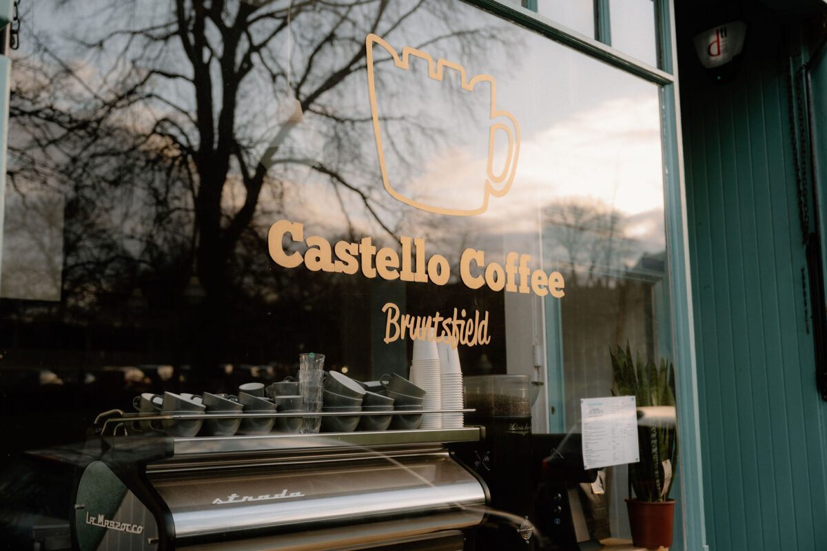 Castello Coffee Bruntsfield window lettering, espresso machine visible through the glass