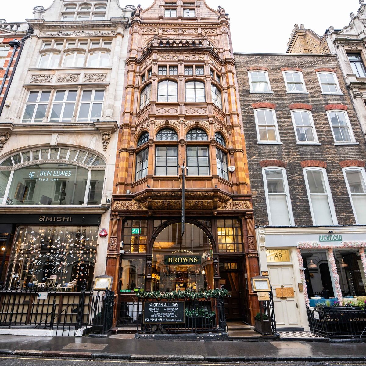 Ornate terracotta facade of Browns restaurant between narrow townhouses on a city street