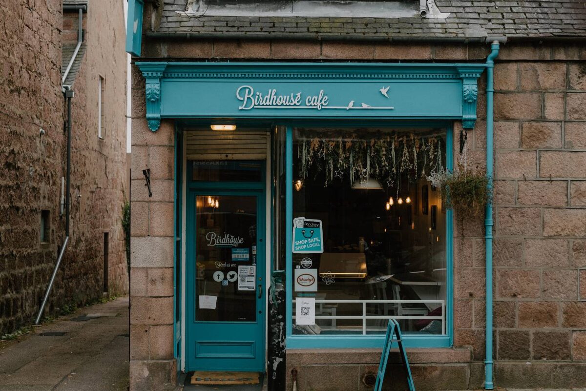 The Birdhouse café's teal shopfront on a granite street in Banchory.