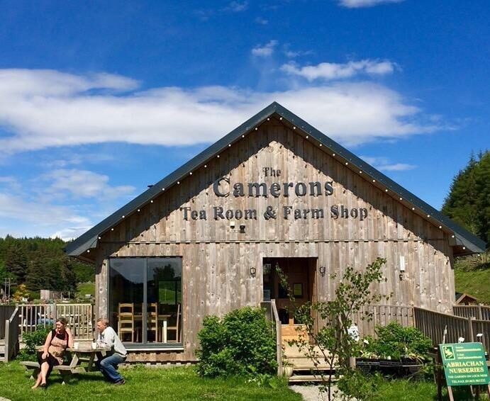 Wooden building with sign reading "The Camerons Tea Room & Farm Shop