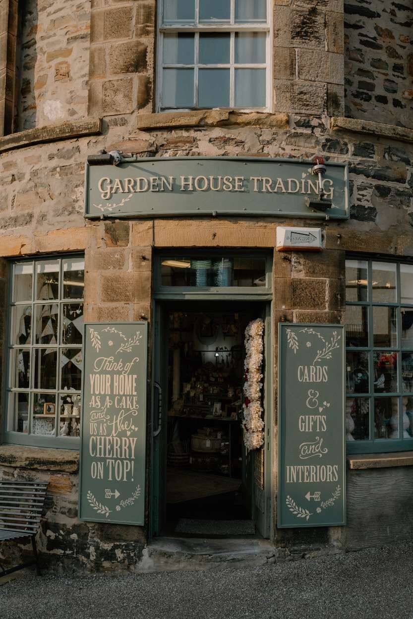 Garden House Trading shopfront with signs for cards, gifts and interiors