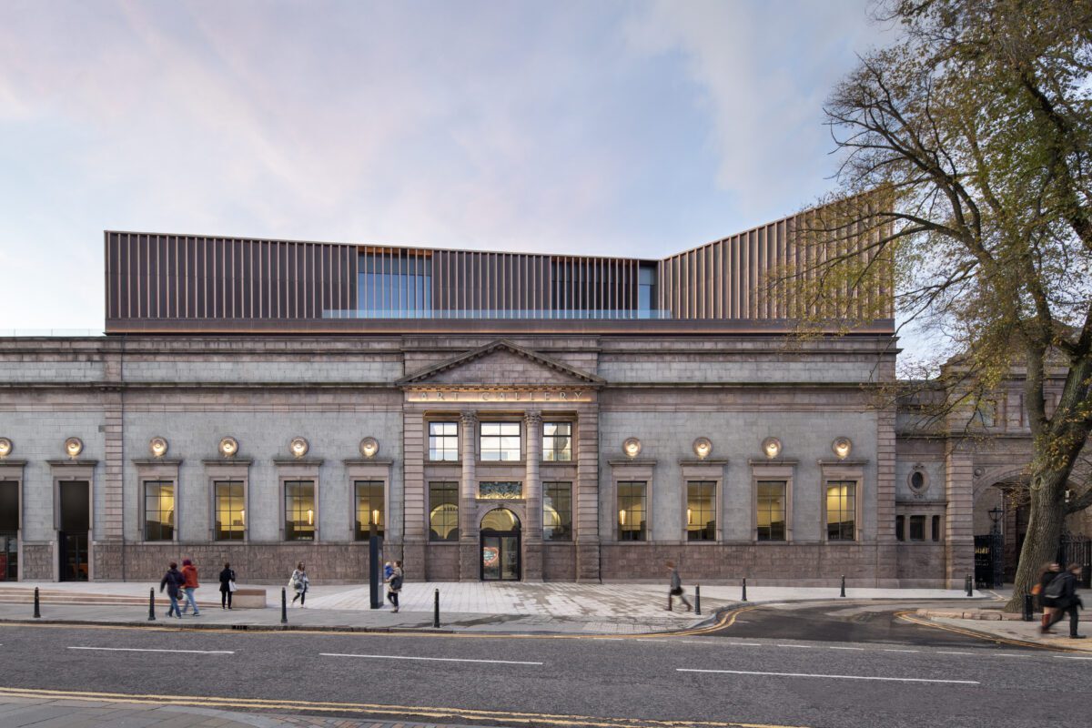 Aberdeen Art Gallery's granite facade topped with a bronze-slatted extension at dusk
