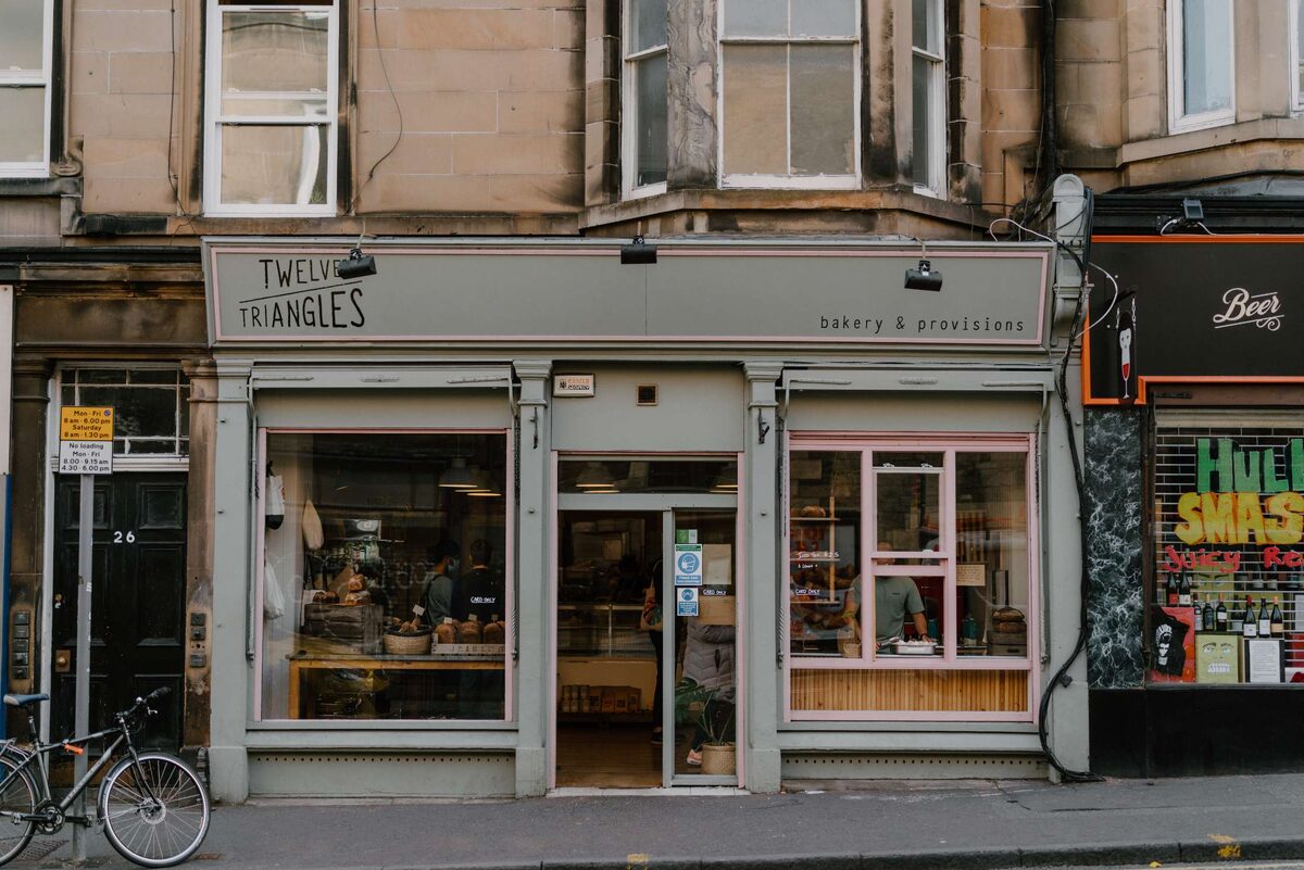 Twelve Triangles bakery and provisions shopfront on a tenement street corner