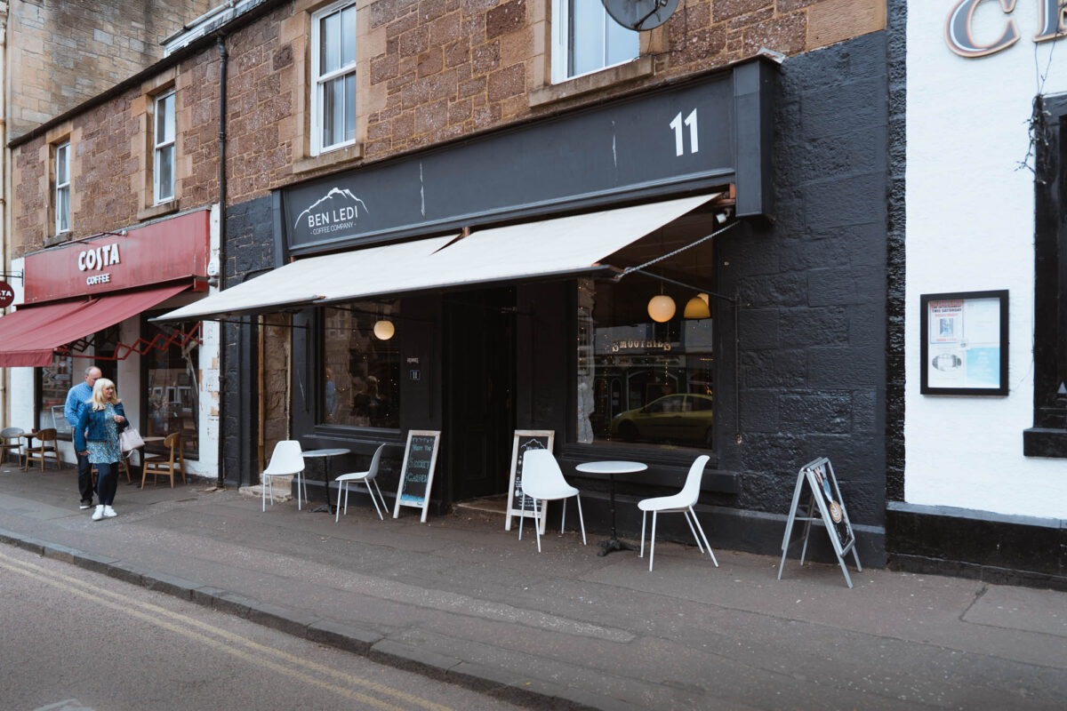 The shopfront at 11 Main Street, Callander, with tables outside.